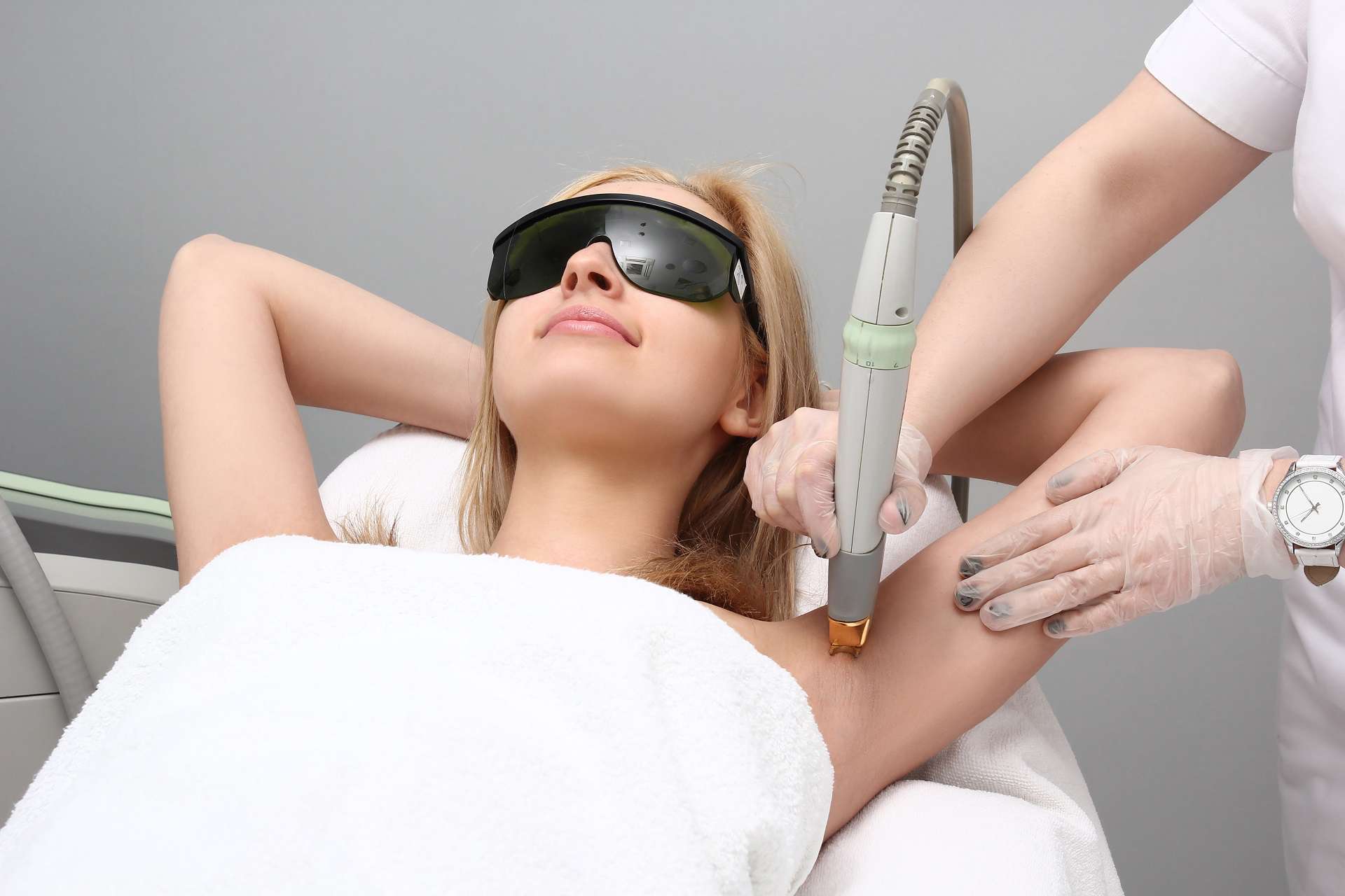 Blonde woman having underarm Laser hair removal epilation. Laser treatment in cosmetic salon | Gladiator Health MD in Riverdale, UT
