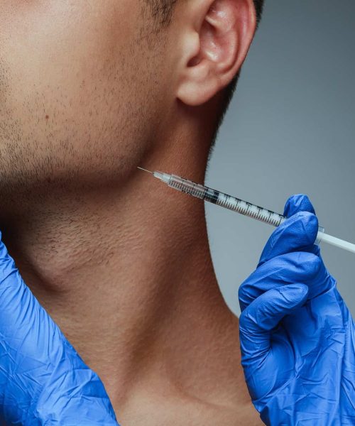 Close-up portrait of a young man isolated on grey studio background | Gladiator Health MD Riverdale UT